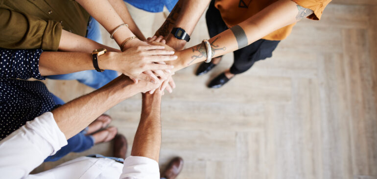 Group of people with their hands in a circle
