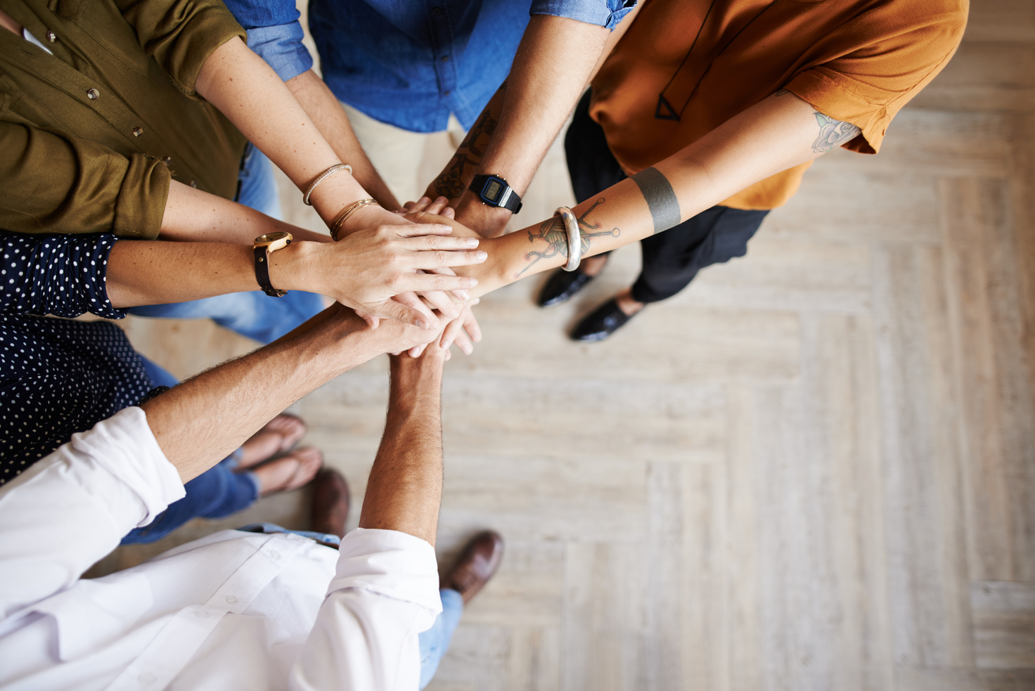 Group of people with their hands in a circle